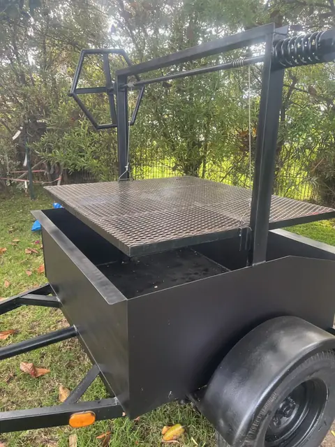 The heavy steel grate and firebox of the Oak & Ember grill